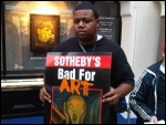 Locked-out Sotheby's worker and poster, photo Kevin Parslow Locked-out Sotheby's worker and poster, photo Kevin Parslow