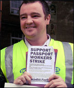 PCS passport workers on strike in Belfast, holding up Socialist Party leaflet, photo by Peter Hadden
