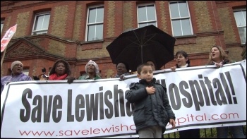 Saturday 24 November, defying cold driving rain, up to 10,000 residents and staff marched to defend Lewisham Accident and Emergency (A&E) and linked arms around it., photo Socialist Party