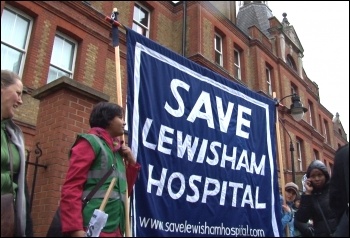 Saturday 24 November, defying cold driving rain, up to 10,000 residents and staff marched to defend Lewisham Accident and Emergency (A&E) and linked arms around it., photo Socialist Party