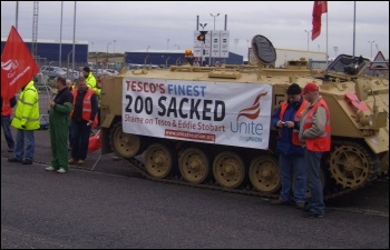 Striking Tesco drivers bring a tank to the picket line with a Unite banner attached , photo A Tice