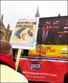 PCS stage outside parliament, with screen showing Budget speech, 20.3.13, photo Sarah Sachs Eldridge
