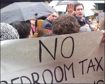 Ed Miliband confronted by anti-bedroom tax protestors demanding that Labour councils refuse to collect the tax, photo Chris Moore