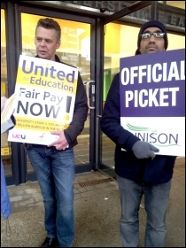 A Unison member (right) striking alongside a UCU member at the University of East London 31.10.13, photo P Mason