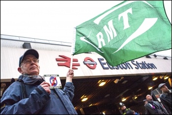 An RMT member takes part in the Euston Station protest, photo Paul Mattsson