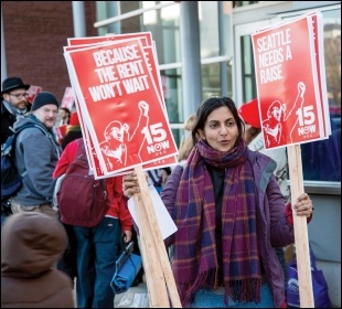 Socialist Seattle councillor Kshama Sawant hands out '$15 now' placards, photo by Socialist Alternative