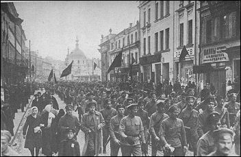 Bolshevik regiments marching to Smolny under banners emblazoned with All Power to the Soviets, Long Live the Revolution.