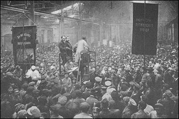 the Putilov Factory in Petrograd. Banners and speakers proclaim the International unity of all races and peoples.