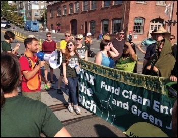 Jess Spear (centre) was part of a 200-strong protest that blocked a BNSF coal train from going through Seattle, photo by Socialist Alternative