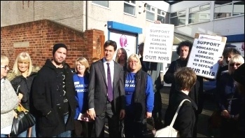 Care UK strikers 'photo-bomb' Miliband 