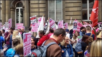 TUSC placards being distributed as the People's Assembly anti-austerity demonstration gathers in the City of London on 20th June., photo Sabah