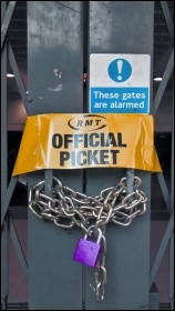 RMT official picket armband on locked station gate, photo Naomi Byron