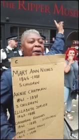 A woman protesting outside Tower Hamlets' new Ripper museum, photo by Socialist Party