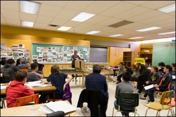 A teacher addresses her class, photo by Karen Stintz (Creative Commons)