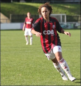Young woman playing football, photo by James Boyes (Creative Commons)