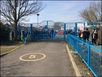 Pent Valley school students rallying inside the gates, and waving a placard outside the gates, during the student strike against closure on 14.4.16, photo by Eric Segal