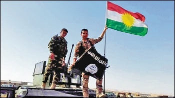 US-backed Kurdish Peshmerga forces replace the Isis flag following territorial gains, photo Creative Commons