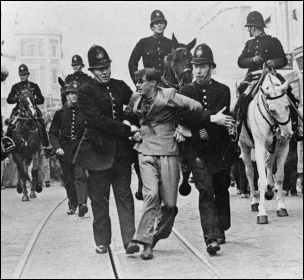 Police drag off an anti-fascist protester