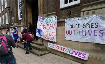 A banner outside the meeting photo COPs campaign