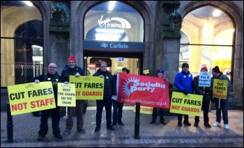 Cut Fares - Not Staff! Carlisle Socialist Party members join RMT and Carlisle Trades Council members outside Carlisle Citadel station on Tuesday 2nd January 2018, photo Craig Johnston