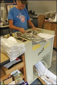 Mark Pickersgill packaging small paper orders for mailing - our print-shop has three full-timers: Mick Cotter, Martin Reynolds and Mark; our circulation manager is Chris Newby