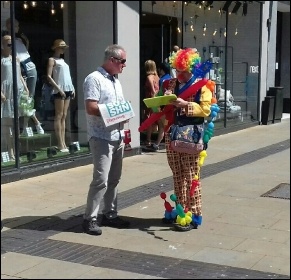 Clown signs NHS petition in Swansea, photo Alec Thraves