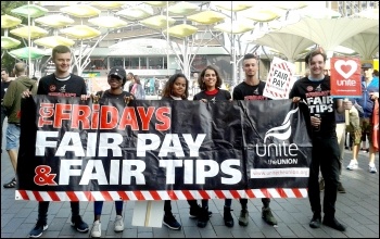 TGIFriday workers at Stratford, London. TGI staff at a number of restaurants have been on strike against cuts in their tips. photo by Pete Mason