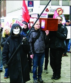 Trade unionists on a benefit cuts 'die in'. Cuts to services, wages, housing, and so on, are killing people early, photo Elaine Evans