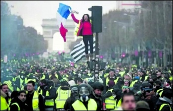 Gilets jaunes flood the historic Champs-Élysées in Paris in scenes reminiscent of the May 1968 general strike, photo Kris Aus67/CC