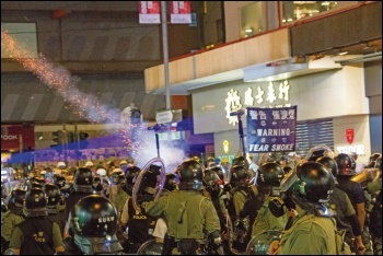 Hong Kong riot police lob tear gas grenades at democracy protesters, photo public domain