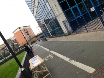 The Socialist Party stall outside Jubilee House, Stratford, east London on 30 March 2020. It clearly shows the table at some distance from the office entrance opposite