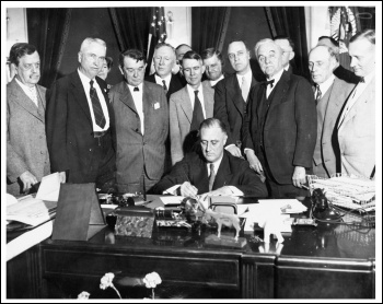 US president Franklin Roosevelt signs an act creating the Tennessee Valley Authority, a federally owned public works corporation