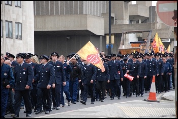 2,500 uniformed firefighters marched with Fire Brigades Union (FBU) flags and placards to protest outside the London Fire Authority (LFA), photo Suzanne Beishon