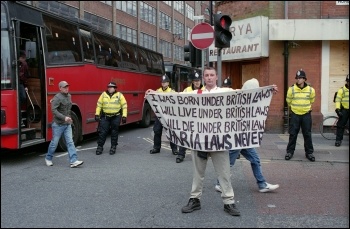 English Defence League supporter fears the unlikely introduction of Sharia law in Britain. The EDL faced a massive counter-demonstration in Leicester, photo Paul Mattsson