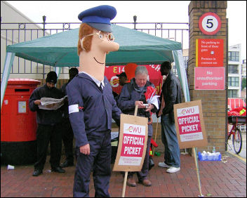 Postman Pat joins the CWU picket line in East London, photo Naomi Byron