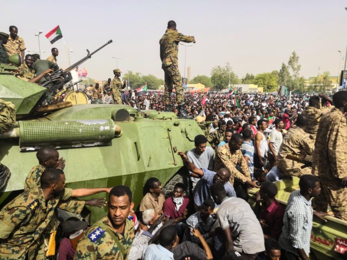 Sudan_coup_military_afp Sudanese soldiers and demonstrators face off during the 2019 coup outside army headquarters in the Sudanese capital Khartoum. Photo: Agence France-Presse