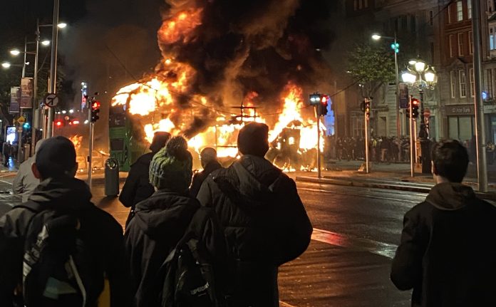 2023_Dublin_riots_-_bus_burning_(cropped) CanalEnthusiast CC scaled Dublin Bus engulfed in flames during the riot Photo: Canalenthusiast/CC