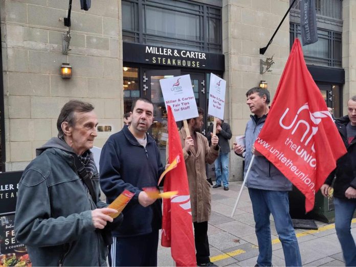 Outside Miller and Carter in Cardiff for national day of action against the company's tip policy. photo: John Williams