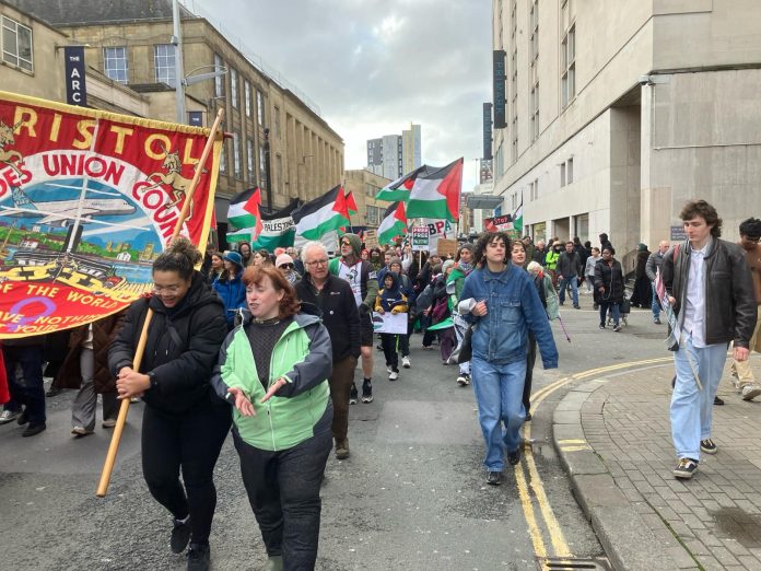 Sheila marches with Bristol Trades Council banner on Gaza demo. Photo: Roger Thomas