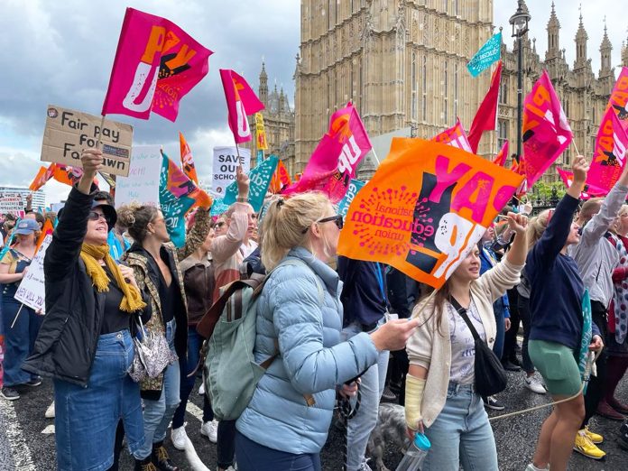 NEU strikers march past Parliament in 2023. Photo: Paula Mitchell