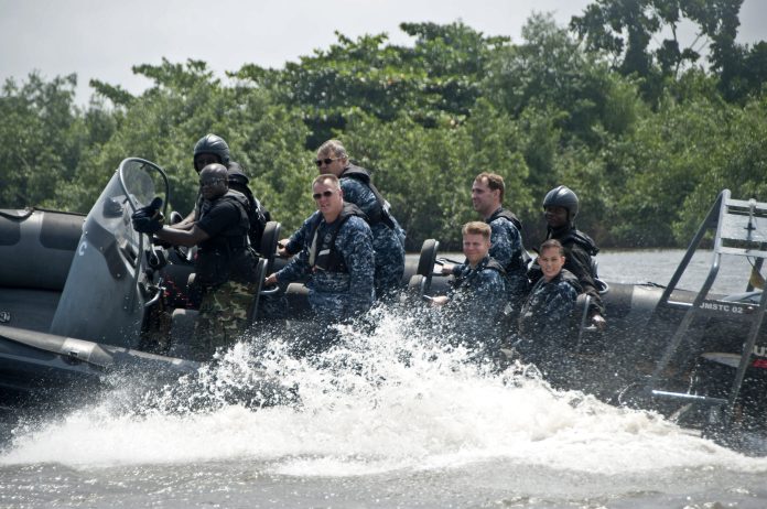 110808-N-XK513-331 US Navy personnel ride along on a Nigerian boat as part of a previous Africa Partnership Station exercise Photo: Public domain
