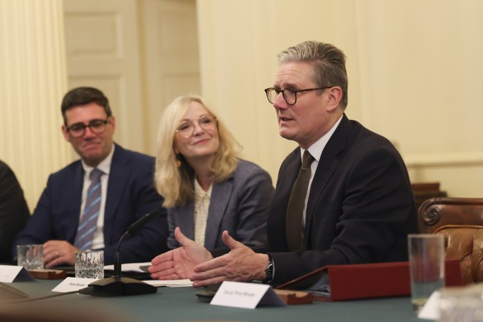 Prime Minister Keir Starmer hosts Metro Mayors Keir Starmer (right) moves to keep Andy Burnham (left) in the background Photo: Simon Dawson/No 10 Downing Street/CC